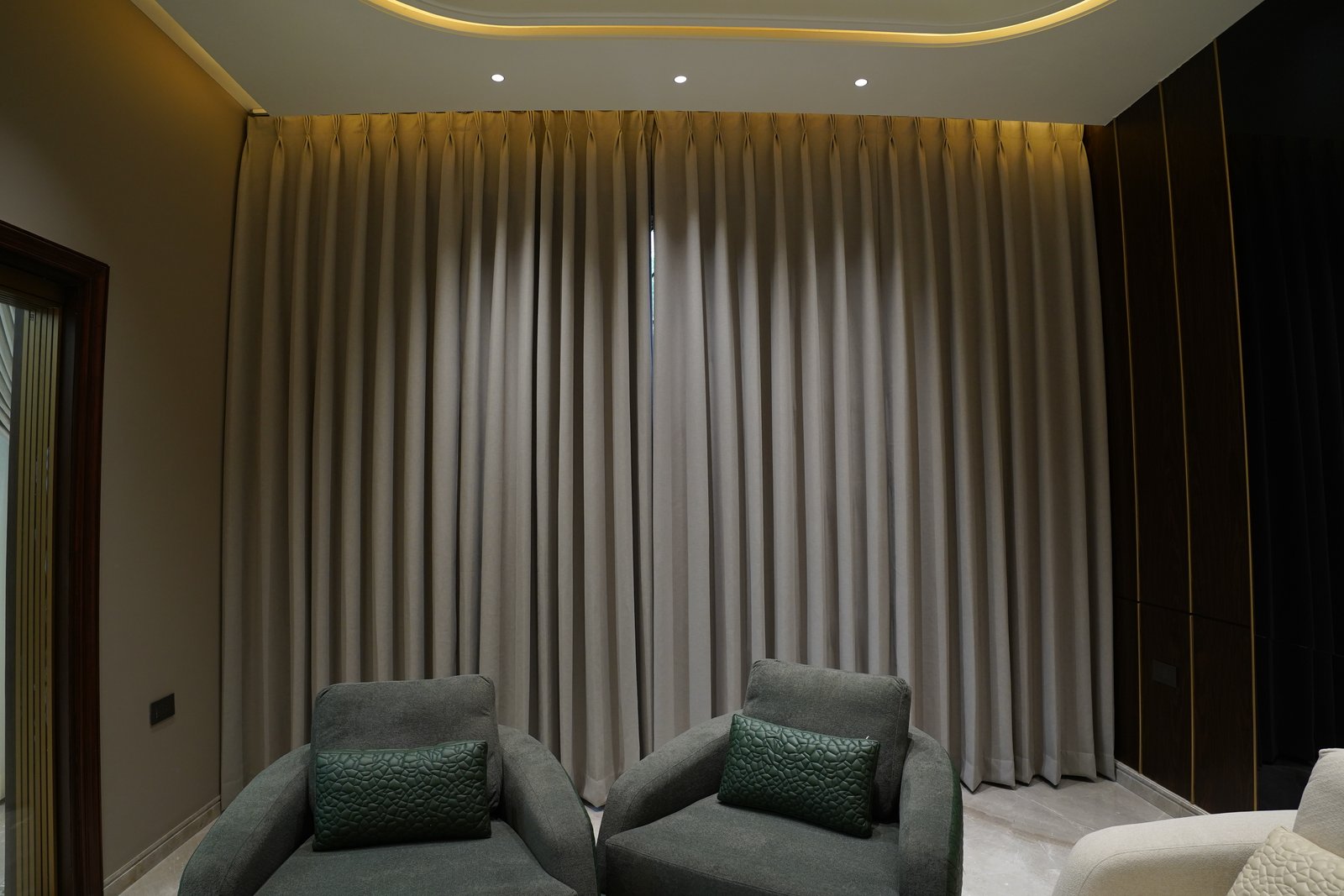 Full-length curtains in a softly lit luxury living room